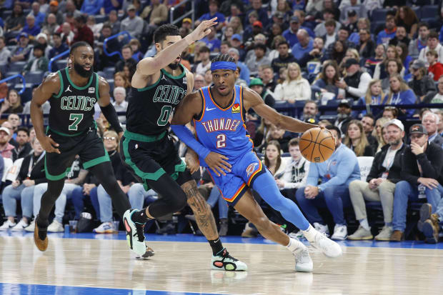 Oklahoma City Thunder guard Shai Gilgeous-Alexander (2) drives to the basket against Boston Celtics forward Jayson Tatum (0).