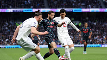 Radu Dragusin and Heung-Min Son in action against Manchester City in May 