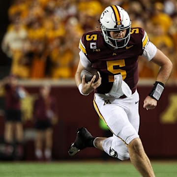 Oct 11, 2025; Minneapolis, Minnesota, USA; Minnesota Golden Gophers quarterback Drake Lindsey (5) runs the ball against the Purdue Boilermakers during the second half at Huntington Bank Stadium. Mandatory Credit: Matt Krohn-Imagn Images