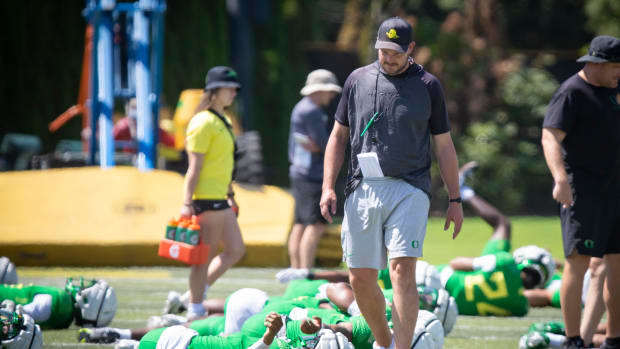 Oregon head coach Dan Lanning walks the field during the Ducks’ fall camp Tuesday