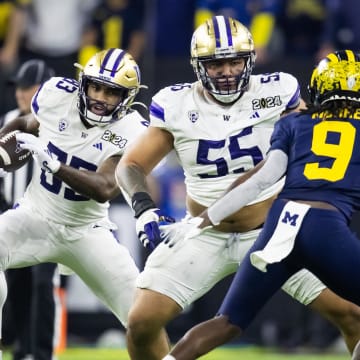 Jan 8, 2024; Houston, TX, USA; Washington Huskies offensive lineman Troy Fautanu (55) blocks for tight end Devin Culp (83) against the Michigan Wolverines during the 2024 College Football Playoff national championship game at NRG Stadium. Mandatory Credit: Mark J. Rebilas-USA TODAY Sports