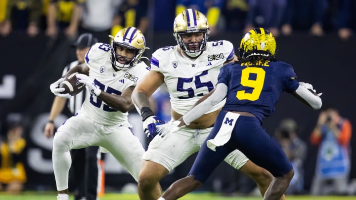 Jan 8, 2024; Houston, TX, USA; Washington Huskies offensive lineman Troy Fautanu (55) blocks for tight end Devin Culp (83) against the Michigan Wolverines during the 2024 College Football Playoff national championship game at NRG Stadium. Mandatory Credit: Mark J. Rebilas-USA TODAY Sports