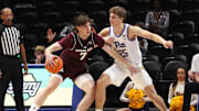 Texas A&M Aggies forward Zach Clemence (7) works the ball to the basket against Pittsburgh Panthers guard Nojus Indrusaitis (25) during the second half at the Petersen Events Center. Mandatory Credit: Charles LeClaire-Imagn Images