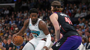 Dec 26, 2024; Memphis, Tennessee, USA; Memphis Grizzlies forward Jaren Jackson Jr. (13) dribbles as Toronto Raptors forward Kelly Olynyk (41) defends during the first quarter at FedExForum. Mandatory Credit: Petre Thomas-Imagn Images