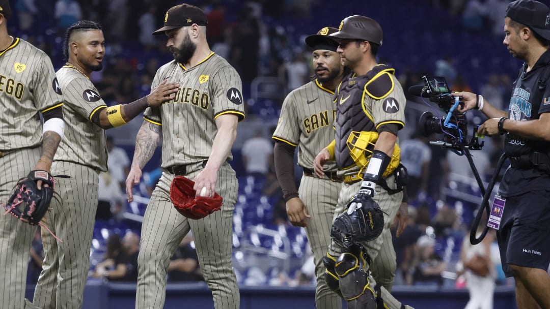 Aug 9, 2024; Miami, Florida, USA;  San Diego Padres designated hitter Luis Arraez (4) and relief pitcher Tanner Scott (66) celebrate their win against the Miami Marlins at loanDepot Park. Mandatory Credit: Rhona Wise-USA TODAY Sports