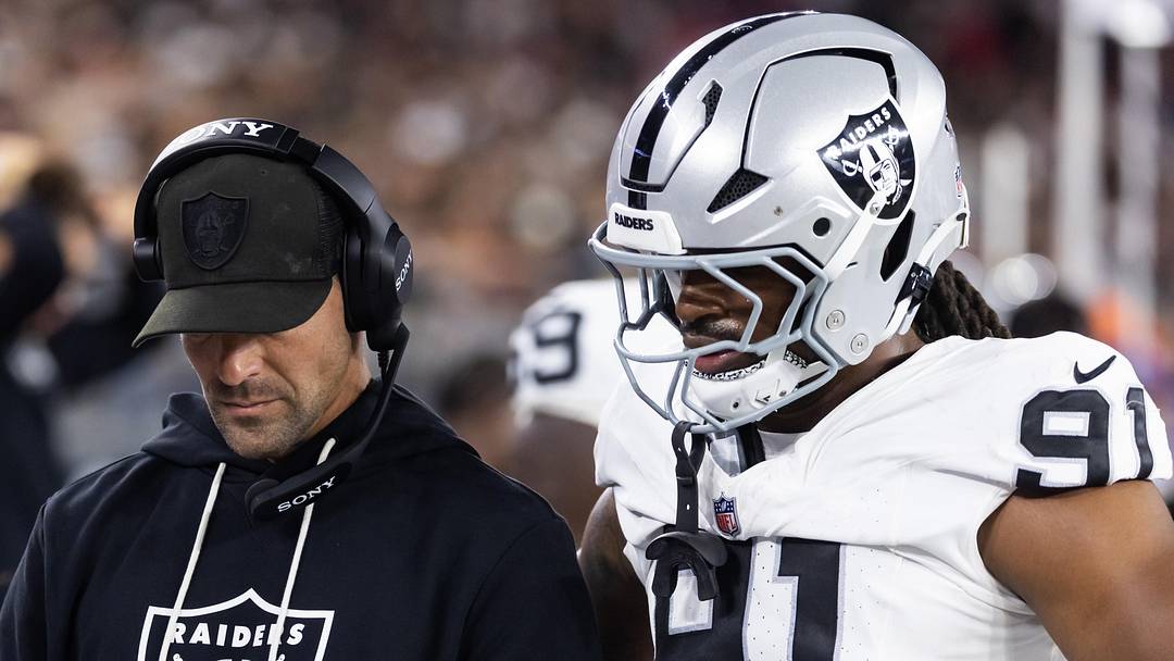 Aug 23, 2025; Glendale, Arizona, USA; Las Vegas Raiders defensive line coach Rob Leonard with defensive end Jahfari Harvey (91) against the Arizona Cardinals during a preseason NFL game at State Farm Stadium. Mandatory Credit: Mark J. Rebilas-Imagn Images