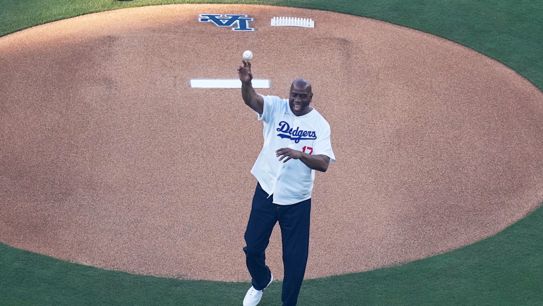 Mar 26, 2026; Los Angeles, California, USA; Former Los Angeles Lakers point guard and basketball hall of fame member Magic Johnson throws out the ceremonial first pitch before the game between the Arizona Diamondbacks and Los Angeles Dodgers at Dodger Stadium. Mandatory Credit: Kirby Lee-Imagn Images