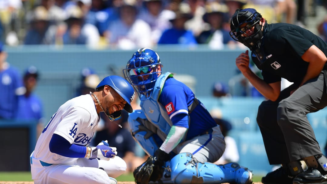 Jun 16, 2024; Los Angeles, California, USA; Los Angeles Dodgers shortstop Mookie Betts (50) reacts after being hit by pitch from Kansas City Royals pitcher Dan Altavilla (54) during the seventh inning at Dodger Stadium. Mandatory Credit: Gary A. Vasquez-USA TODAY Sports