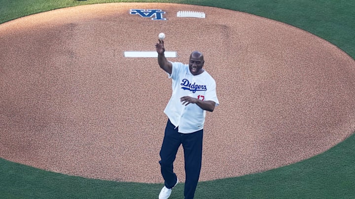 Mar 26, 2026; Los Angeles, California, USA; Former Los Angeles Lakers point guard and basketball hall of fame member Magic Johnson throws out the ceremonial first pitch before the game between the Arizona Diamondbacks and Los Angeles Dodgers at Dodger Stadium. Mandatory Credit: Kirby Lee-Imagn Images