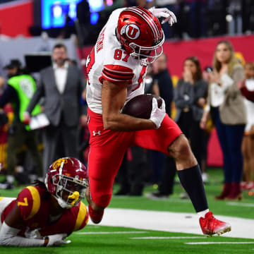 Dec 2, 2022; Las Vegas, NV, USA; Utah Utes tight end Thomas Yassmin (87) runs the ball for a touchdown ahead of Southern California Trojans defensive back Calen Bullock (7) during the second half in the PAC-12 Football Championship at Allegiant Stadium. Mandatory Credit: Gary A. Vasquez-USA TODAY Sports