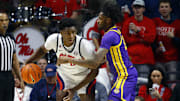 Jan 11, 2025; Oxford, Mississippi, USA; Mississippi Rebels forward Malik Dia (0) drives to the basket as LSU Tigers forward Daimion Collins (10) defends during the first half at The Sandy and John Black Pavilion at Ole Miss. Mandatory Credit: Petre Thomas-Imagn Images