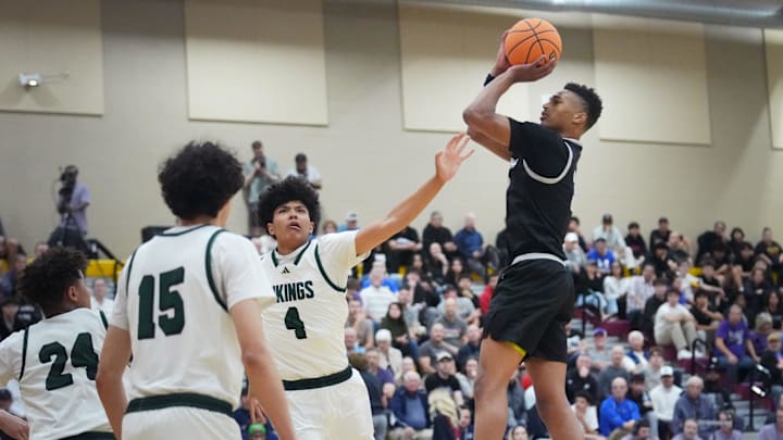 Millennium Tigers guard Cameron Holmes (3) shoots the ball over Sunnyslope Vikings forward Cristian Simmons (4) during their Open Division boys basketball state semifinals game at Chaparral High School in Phoenix on March 5, 2025.