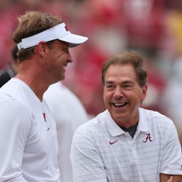 Oct 2, 2021; Tuscaloosa, Alabama, USA;  Mississippi Rebels head coach Lane Kiffin talks with Alabama Crimson Tide head coach Nick Saban before the start of an NCAA college football game at Bryant-Denny Stadium. Mandatory Credit: Butch Dill-USA TODAY Sports