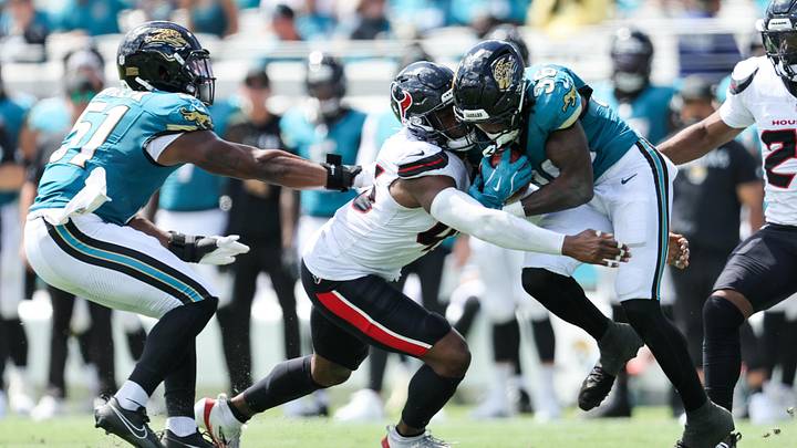 Sep 21, 2025; Jacksonville, Florida, USA;  Houston Texans linebacker E.J. Speed (45) tackles Jacksonville Jaguars running back Lequint Allen Jr. (36) during the second quarter at EverBank Stadium. Mandatory Credit: Morgan Tencza-Imagn Images