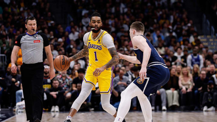 Apr 29, 2024; Denver, Colorado, USA; Los Angeles Lakers guard D'Angelo Russell (1) controls the ball as Denver Nuggets guard Christian Braun (0) guards in the first quarter during game five of the first round for the 2024 NBA playoffs at Ball Arena. Mandatory Credit: Isaiah J. Downing-USA TODAY Sports