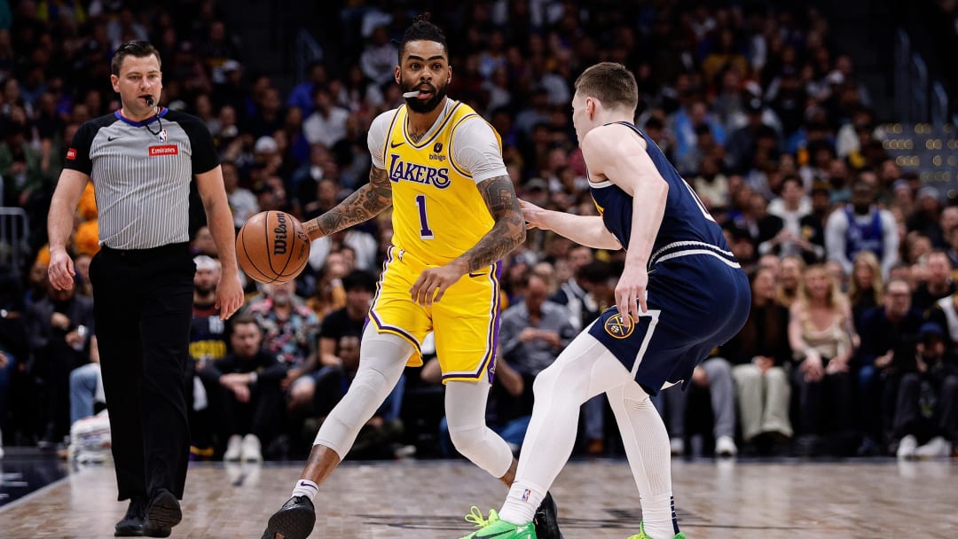 Apr 29, 2024; Denver, Colorado, USA; Los Angeles Lakers guard D'Angelo Russell (1) controls the ball as Denver Nuggets guard Christian Braun (0) guards in the first quarter during game five of the first round for the 2024 NBA playoffs at Ball Arena. Mandatory Credit: Isaiah J. Downing-USA TODAY Sports