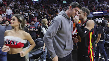 Dec 22, 2023; Miami, Florida, USA; Atlanta Hawks guard Trae Young (11) talks to Real Madrid goalkeeper Thibaut Courtois after the game against the Miami Heat at Kaseya Center. Mandatory Credit: Sam Navarro-Imagn Images