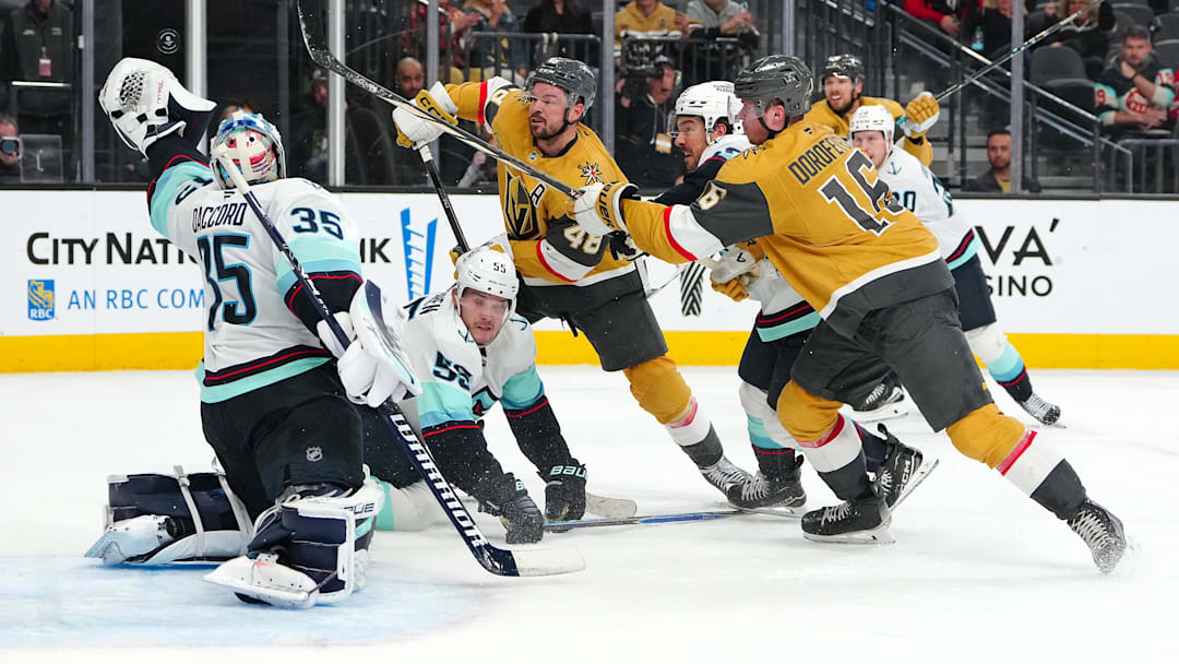 Jan 31, 2026; Las Vegas, Nevada, USA; Seattle Kraken goaltender Joey Daccord (35) looks to glove a loose puck as Vegas Golden Knights center Tomas Hertl (48) and right wing Pavel Dorofeyev (16) look for a rebound during the final seconds of the third period at T-Mobile Arena. Mandatory Credit: Stephen R. Sylvanie-Imagn Images