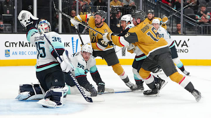 Jan 31, 2026; Las Vegas, Nevada, USA; Seattle Kraken goaltender Joey Daccord (35) looks to glove a loose puck as Vegas Golden Knights center Tomas Hertl (48) and right wing Pavel Dorofeyev (16) look for a rebound during the final seconds of the third period at T-Mobile Arena. Mandatory Credit: Stephen R. Sylvanie-Imagn Images
