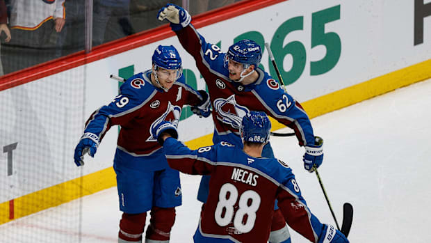 Colorado Avalanche center Nathan MacKinnon celebrates his goal with center Martin Necas and left wing Artturi Lehkonen.