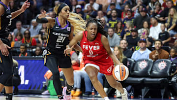 Sep 25, 2024; Uncasville, Connecticut, USA; Indiana Fever guard Kelsey Mitchell (0) drives to the basket defended by Connecticut Sun guard DiJonai Carrington (21) during game two of the first round of the 2024 WNBA Playoffs at Mohegan Sun Arena. Mandatory Credit: Paul Rutherford-Imagn Images