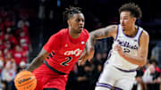Cincinnati Bearcats guard Jizzle James (2) attempts to drive past Kansas State Wildcats guard Max Jones (2) in the first half of a NCAA men’s basketball game between the Cincinnati Bearcats and Kansas State Wildcats, Wednesday, March 5, 2025, at Fifth Third Arena in Cincinnati.