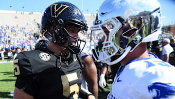 Sep 23, 2023; Nashville, Tennessee, USA; Vanderbilt Commodores quarterback AJ Swann (5) talks with Kentucky Wildcats quarterback Devin Leary (13) after a game at FirstBank Stadium. Mandatory Credit: Christopher Hanewinckel-Imagn Images