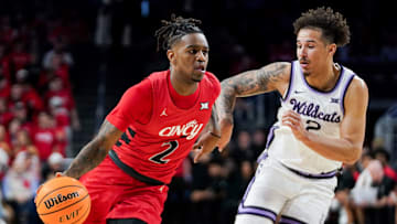 Cincinnati Bearcats guard Jizzle James (2) attempts to drive past Kansas State Wildcats guard Max Jones (2) in the first half of a NCAA men’s basketball game between the Cincinnati Bearcats and Kansas State Wildcats, Wednesday, March 5, 2025, at Fifth Third Arena in Cincinnati.