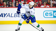 Mar 12, 2025; Calgary, Alberta, CAN; Vancouver Canucks defenseman Quinn Hughes (43) shoots the puck against the Calgary Flames during the first period at Scotiabank Saddledome. Mandatory Credit: Sergei Belski-Imagn Images