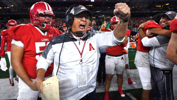 Albany coach Denney Faith cheers after winning the 2022 UIL Class 2A Division II state football title over Mart.