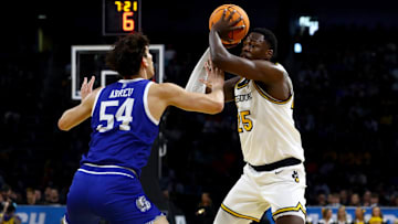 Mar 20, 2025; Wichita, KS, USA; Missouri Tigers guard Mark Mitchell (25) looks to pass against Drake Bulldogs forward Daniel Abreu (54) in the first half of a first round men’s NCAA Tournament game at Intrust Bank Arena. Mandatory Credit: Nick Tre. Smith-Imagn Images