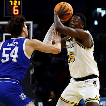 Mar 20, 2025; Wichita, KS, USA; Missouri Tigers guard Mark Mitchell (25) looks to pass against Drake Bulldogs forward Daniel Abreu (54) in the first half of a first round men’s NCAA Tournament game at Intrust Bank Arena. Mandatory Credit: Nick Tre. Smith-Imagn Images