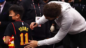Jan 5, 2022; Sacramento, California, USA; Atlanta Hawks guard Trae Young (11) signs the jersey of a young fan after the game against the Sacramento Kings at Golden 1 Center. Mandatory Credit: Kelley L Cox-Imagn Images