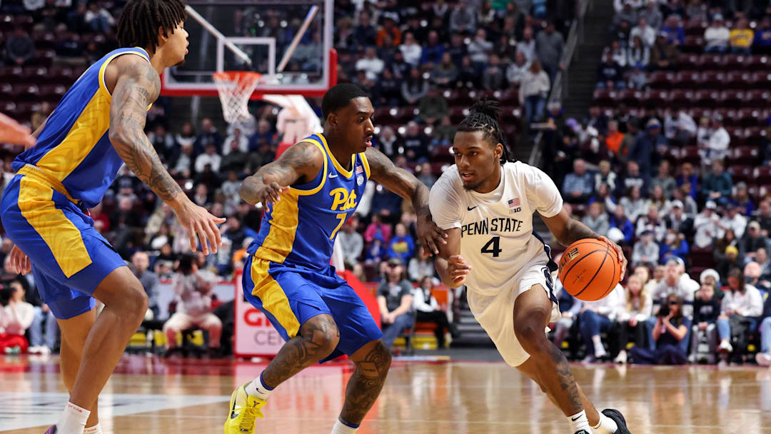 Penn State Nittany Lions guard Kayden Mingo (4) dribbles the ball around Pittsburgh Panthers guard Damarco Minor (7) during the first half at Giant Center. 