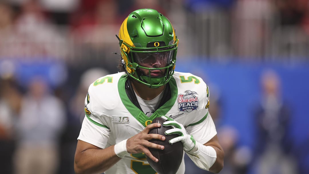 Jan 9, 2026; Atlanta, GA, USA; Oregon Ducks quarterback Dante Moore (5) looks to pass against the Indiana Hoosiers during the first half of the 2025 Peach Bowl and semifinal game of the College Football Playoff at Mercedes-Benz Stadium. Mandatory Credit: Brett Davis-Imagn Images