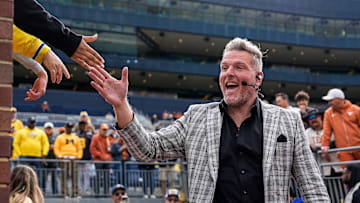 ESPN College Game Day's Pat McAfee high-fives fans as he takes the field before the game between Michigan and Texas at Michigan Stadium in Ann Arbor on Saturday, September 7, 2024.