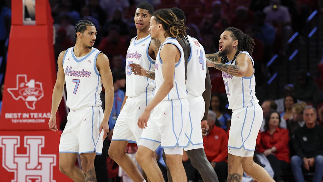 Jan 13, 2026; Houston, Texas, USA;  Houston Cougars guard Milos Uzan (7) leads his teammates out onto the floor after a West Virginia Mountaineers timeout in the first half at Fertitta Center.