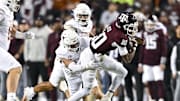Nov 30, 2024; College Station, Texas, USA; Texas A&M Aggies quarterback Marcel Reed (10) is tackled by Texas Longhorns defensive back Michael Taaffe (16) during the first quarter. The Longhorns defeated the Aggies 17-7 at Kyle Field. Mandatory Credit: Maria Lysaker-Imagn Images  