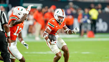 Nov 8, 2025; Miami Gardens, Florida, USA; Miami Hurricanes defensive back Jakobe Thomas (8) returns an interception against the Syracuse Orange during the third quarter at Hard Rock Stadium. Mandatory Credit: Jeff Romance-Imagn Images