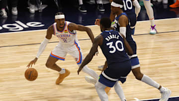 Oklahoma City Thunder guard Shai Gilgeous-Alexander dribbles against Julius Randle during the 2025 NBA Playoffs