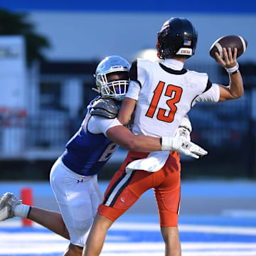 IMG Academy defensive lineman Jake Kruel wraps up Cocoa High quarterback Brady Hart