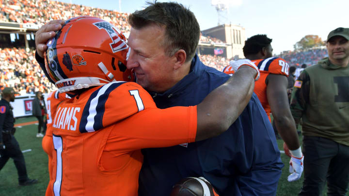 Nov 11, 2023; Champaign, Illinois, USA;  Illinois Fighting Illini head coach Bret Bielema hugs player Isaiah Williams (1) after Williams scored the winning touchdown in overtime to defeat the Indiana Hoosiers at Memorial Stadium. Mandatory Credit: Ron Johnson-USA TODAY Sports