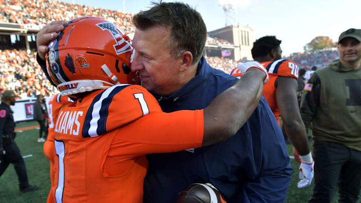 Nov 11, 2023; Champaign, Illinois, USA;  Illinois Fighting Illini head coach Bret Bielema hugs player Isaiah Williams (1) after Williams scored the winning touchdown in overtime to defeat the Indiana Hoosiers at Memorial Stadium. Mandatory Credit: Ron Johnson-Imagn Images
