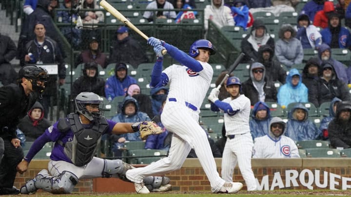 Apr 1, 2024; Chicago, Illinois, USA; Chicago Cubs center fielder Cody Bellinger (24) hits a two run single against the Colorado Rockies during the seventh inning at Wrigley Field.