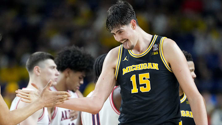 Michigan Wolverines center Aday Mara (15) and forward Yaxel Lendeborg (23) celebrate a made basket Saturday, April 4, 2026, during a Final Four game against the Arizona Wildcats at Lucas Oil Stadium in Indianapolis.