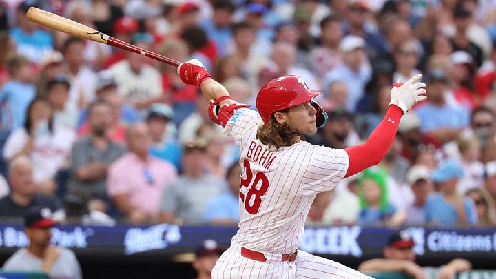 Aug 4, 2026; Philadelphia, Pennsylvania, USA; Philadelphia Phillies third baseman Alec Bohm (28) hits an RBI sacrifice fly against the Washington Nationals during the third inning at Citizens Bank Park. Mandatory Credit: Bill Streicher-Imagn Images