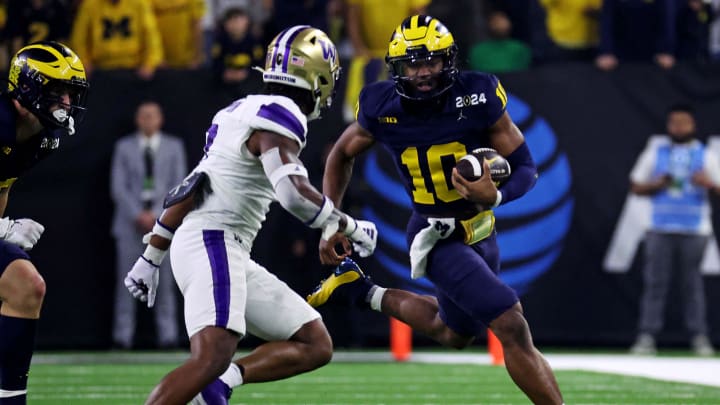 Jan 8, 2024; Houston, TX, USA; Michigan Wolverines quarterback Alex Orji (10) runs the ball against Washington Huskies cornerback Dominique Hampton (7) during the second quarter in the 2024 College Football Playoff national championship game at NRG Stadium. Mandatory Credit: Troy Taormina-USA TODAY Sports