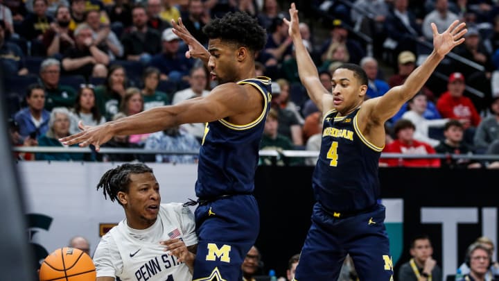 Penn State guard Ace Baldwin Jr. (1) looks to pass against Michigan guard Jace Howard (25) and guard Nimari Burnett (4) during the second half of the First Round of Big Ten tournament at Target Center in Minneapolis, Minn. on Wednesday, March 13, 2024.