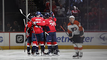 Oct 23, 2024; Washington, District of Columbia, USA; Washington Capitals center Nic Dowd (26) celebrates with teammates after scoring a goal against the Philadelphia Flyers in the second period at Capital One Arena. Mandatory Credit: Geoff Burke-Imagn Images