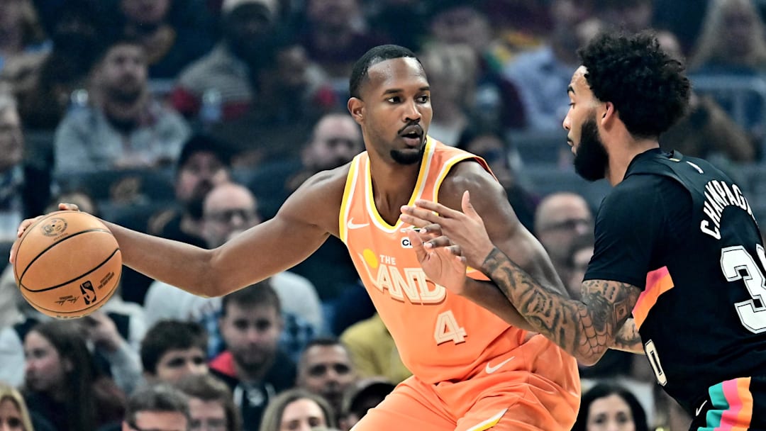 Dec 5, 2025; Cleveland, Ohio, USA; Cleveland Cavaliers center Evan Mobley (4) drives to the basket against San Antonio Spurs forward Julian Champagnie (30) during the first half at Rocket Arena. Mandatory Credit: Ken Blaze-Imagn Images